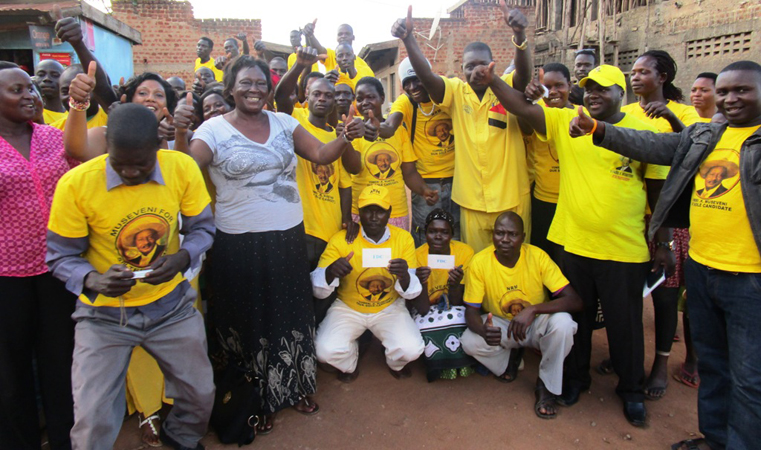 Kalang memmbers dressed in NRM shirt pose with Santa Oketta special presidential assistance Northern Uganda