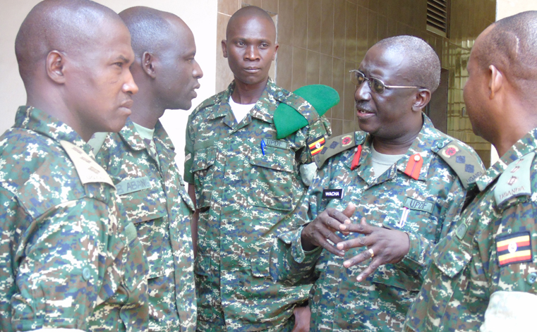 Col. Charles Wacha Angulo, the Director Human Rights Affairs in UPDF chatting with UPDF officers during on Human Rights in Gulu recently. Photo by James Owich