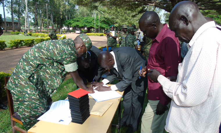 Discharged army officers Line up to sign against their names during a retirement exercise at 4th Division Army Barracks in Gulu on Friday