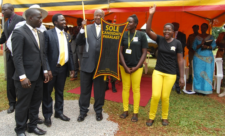 Mr Museveni holds a shield and a spear given to him by NRM youth in Gulu district on Tuesday