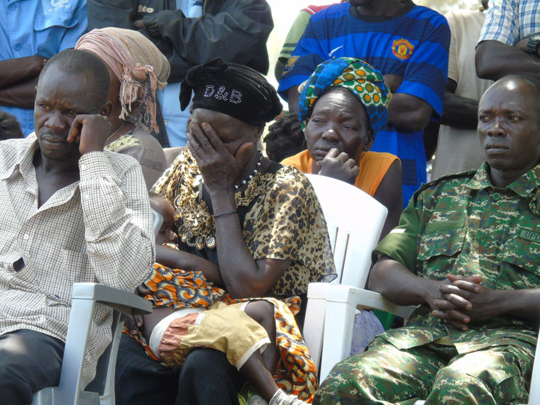 Some of the urvivors listen at the International Criminal Justice Day at Lukodi Massacre Site in Gulu district on Friday