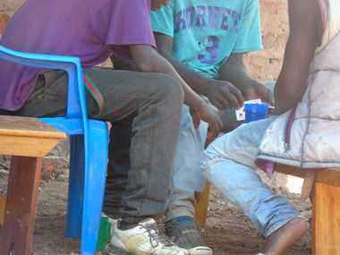 Young men play cards for money recently in Gulu town. Photo by James Owich