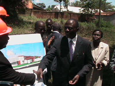 Institute chairman handing over the plan to the contractor