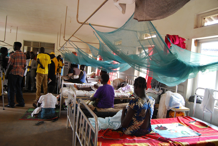 Some of the mothers at the Kitgum general hospital maternity ward on their beds while others are seated on the floor