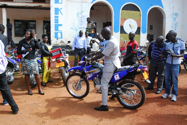 Gulu LCV Chairman Mr Martin Ojara Mapenduzi tries out one of the motorcycles tht were donated by JICA to the Gulu district local government