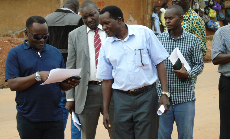 Gabindadde – Musoke, the Permanent Secretary in the Ministry of Lands, Housing and Urban Development (blue shirt) and Terrence Odonga, (Left), the Gulu Municipal Council Engineer inspecting new roads under construction