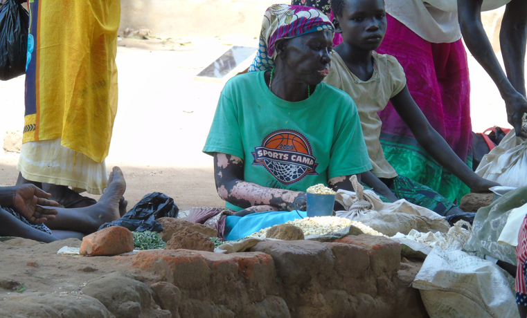 A woman trades in maize cereals in Parabongo Market, Lamogi Sub County in Gulu district