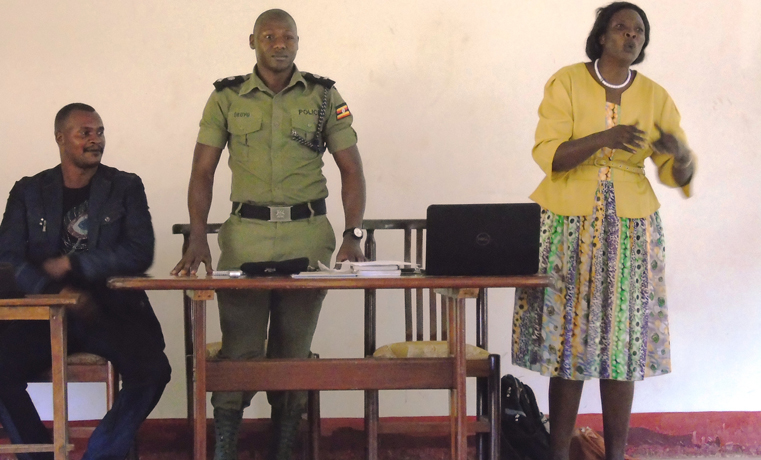 Juliet Adoch, the Chairperson for National Traditional Healers, Herbalists and Birth Attendants Association for Gulu and Martin Okoyo, the Gulu District Police Commander (DPC) addressing traditional healers and herbalists in Gulu town