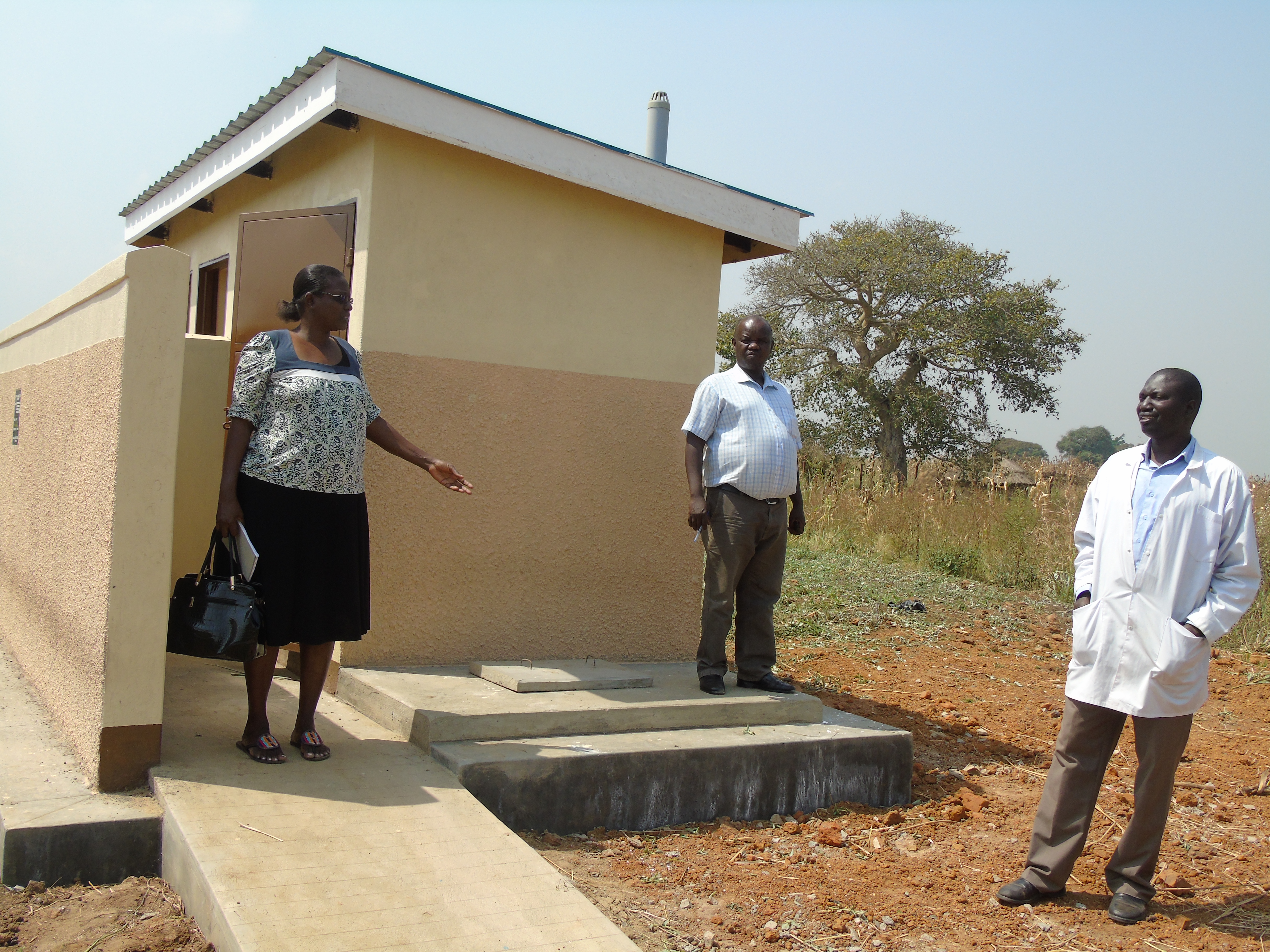 Gulu CAO inpects the New Latrine with the Incharge and the district Engineer