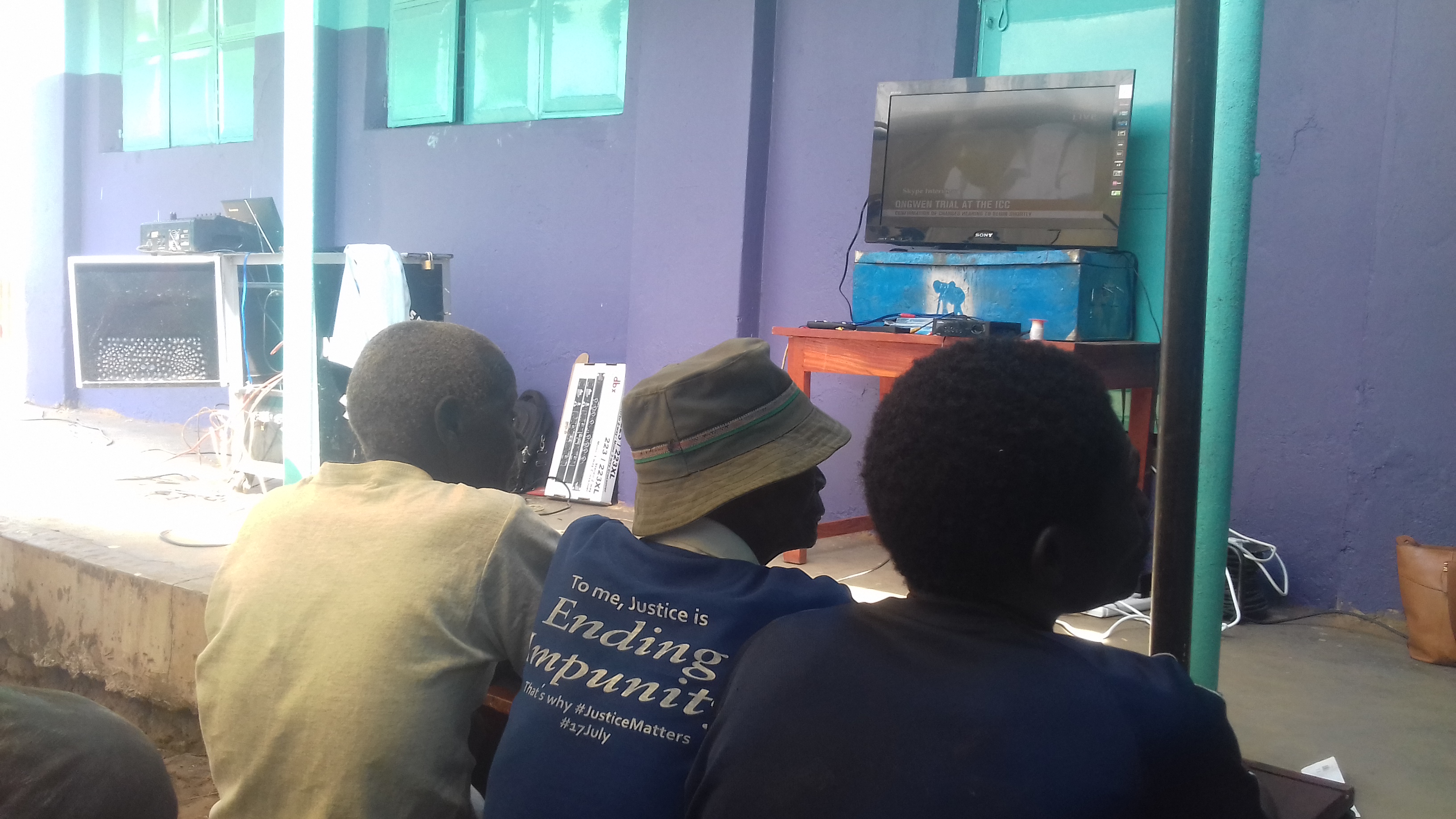 Resdents of Lukodi village watching the live telecast of the former LRA commander Dominic Ongwen's confirmation hearing at ICC on Thursday, PHOTO BY DENIS OTIM
