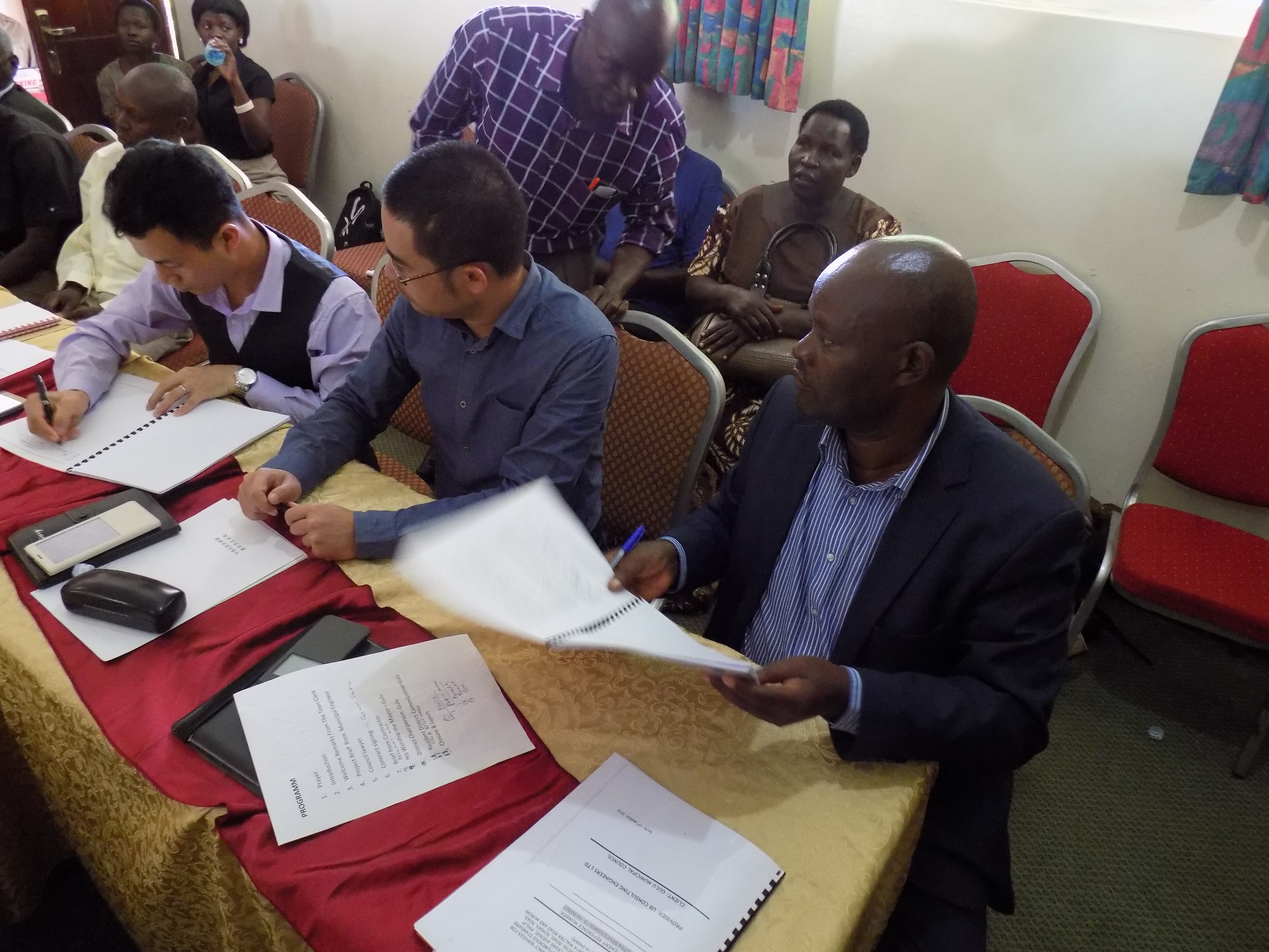 Gulu Town Clerk signing the contracts with the Chinese Company