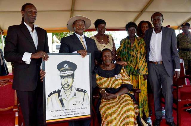 Gertrude Auma Oryema and someof the family members of the late Oryema seated pausing with President Museveni
