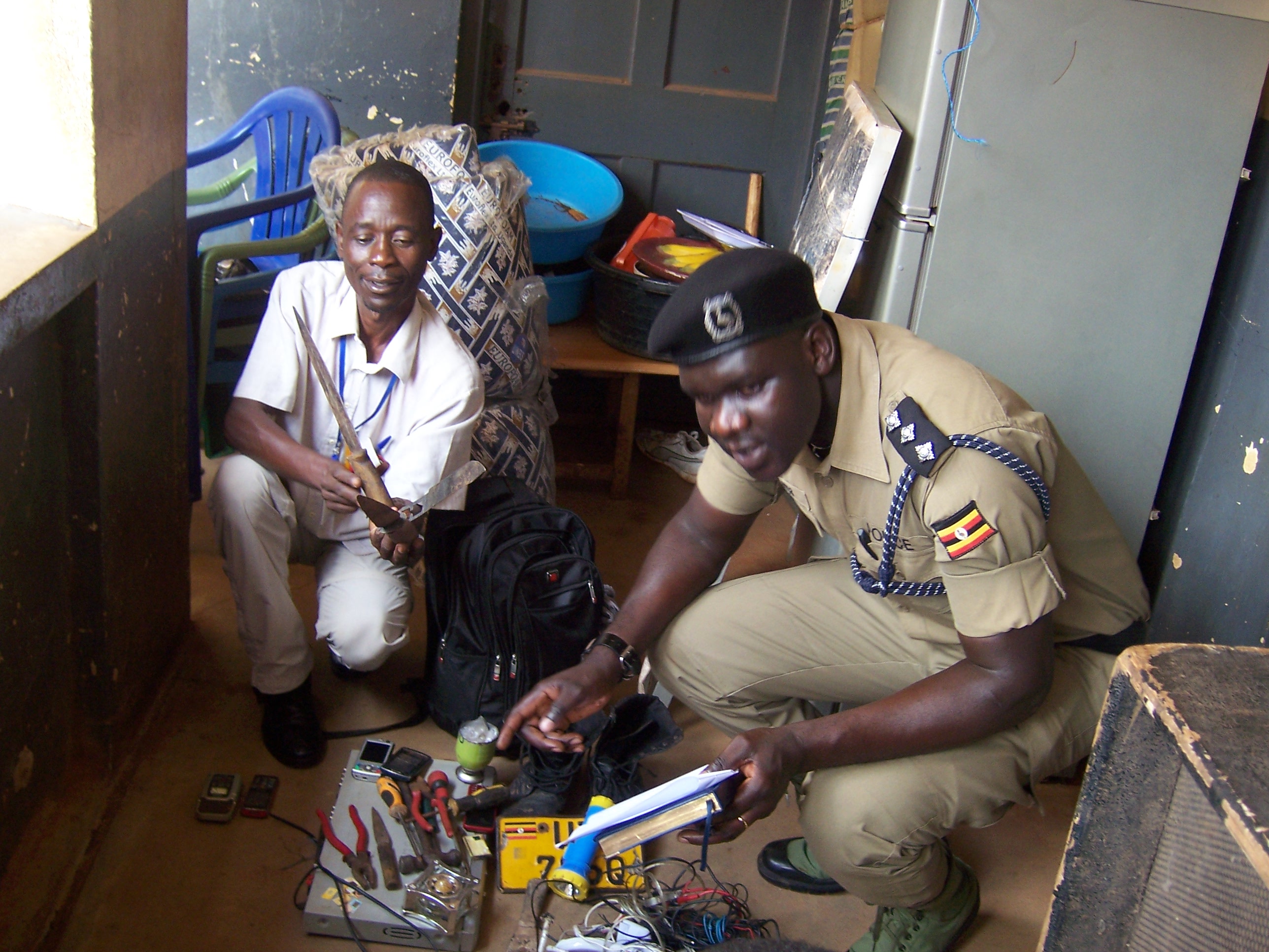 police-looks-at-the-recovered-items-packed-at-cps-gulu